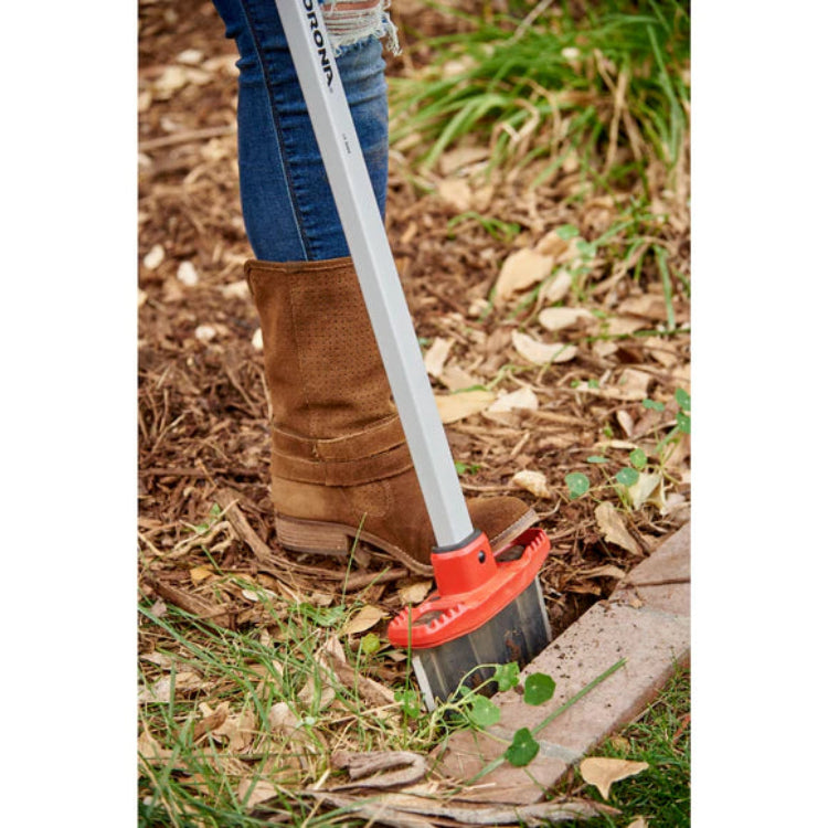 Closeup of Corona EdgeMASTER cutting a defined edge between mulch bed and brick pavers.