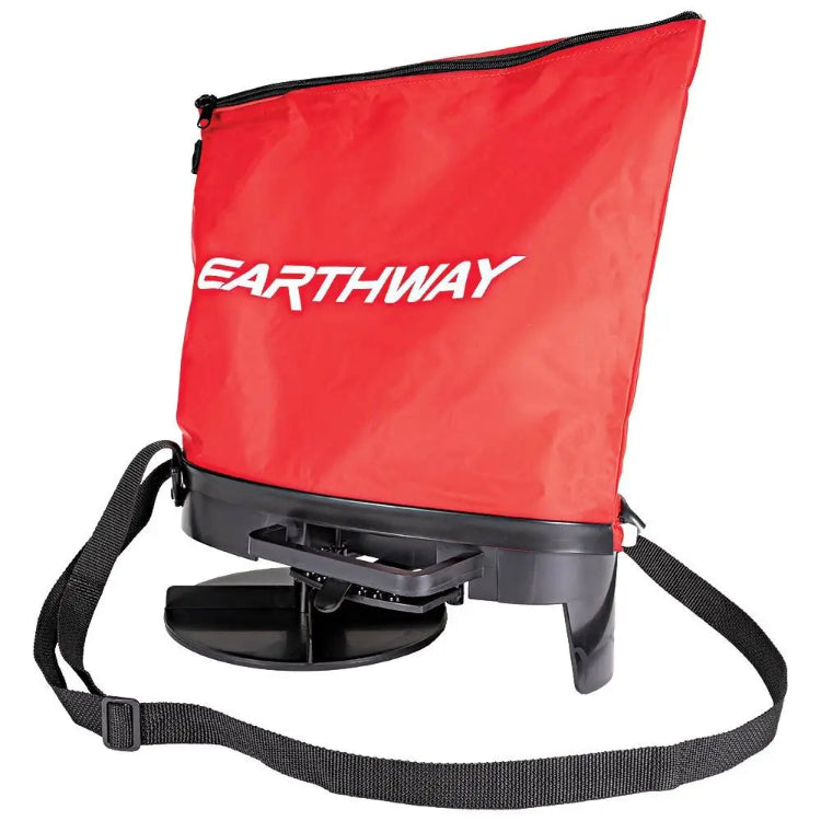 Earthway over-shoulder bag spreader with red bag, hand crank, and adjustable strap.