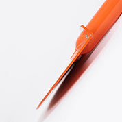 Extreme closeup of the cutting tip of the half-moon turf edger blade.