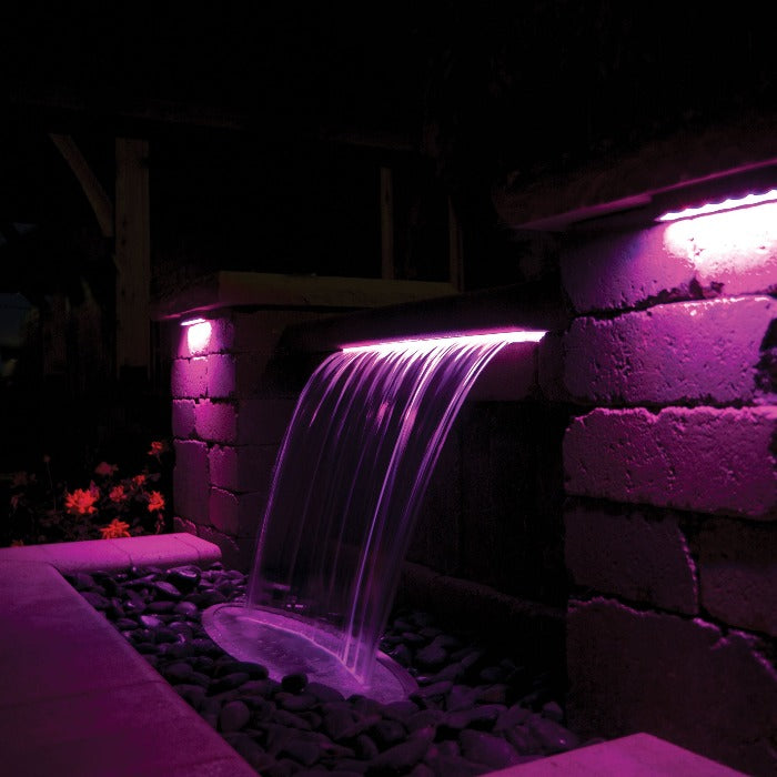 Color Changing Colorfalls LED Waterfall: Purple light illuminating modern backyard water feature.
