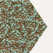 Close-up view of teal and brown fertilizer granules.
