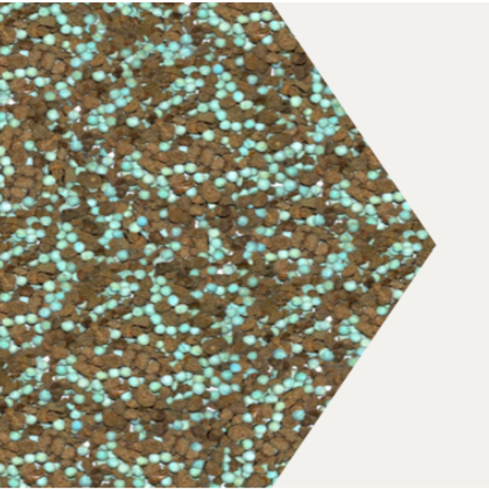 Close-up view of teal and brown fertilizer granules.
