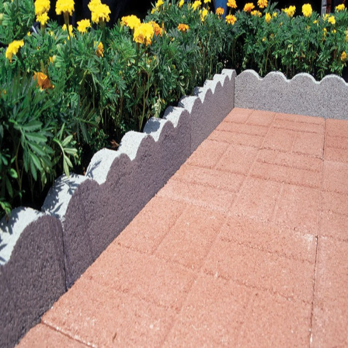 Scallops Edger: Gray concrete garden edging with scalloped design, perfect for landscaping.
