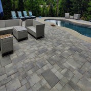 City Stone Supra Combo 60mm pavers: Gray, multi-sized stone patio around pool and seating area.

