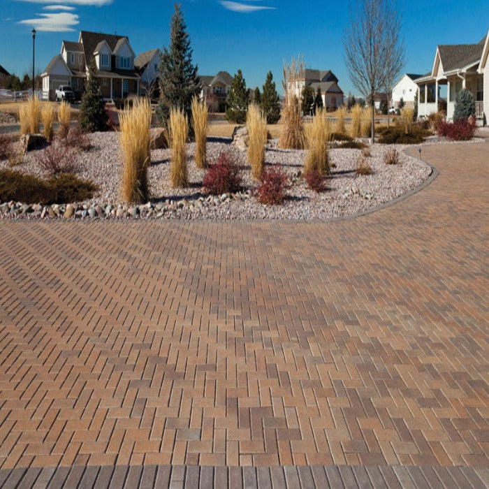 60mm rectangular pavers in a herringbone driveway pattern, landscaped setting.
