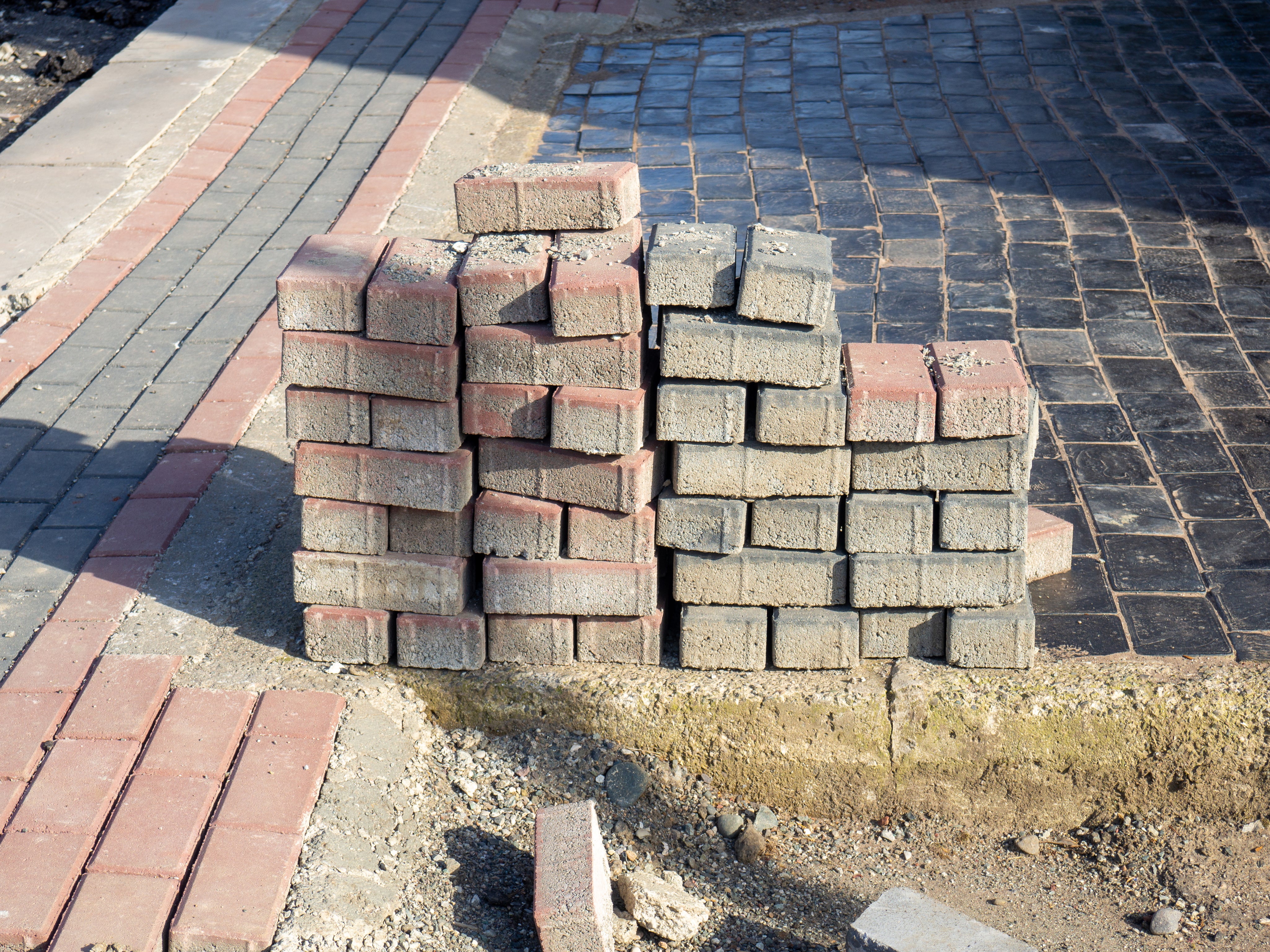 pavement-repair-laying-out-paving-stones-repair-work.jpg