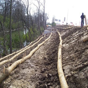 Straw wattles for erosion control on a sloped embankment.
