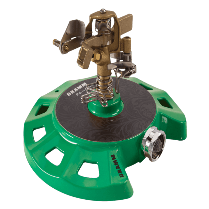 Green metal circular sprinkler with brass nozzle, designed for efficient lawn watering.
