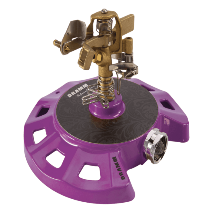 Purple circular sprinkler with brass accents; water efficient design.
