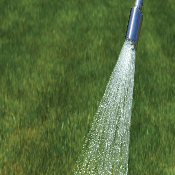 Aluminum watering nozzle spraying water onto a lush green lawn.
