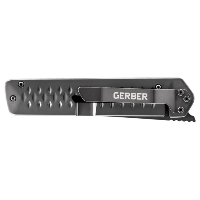 Dark gray folding knife with textured handle and serrated blade.
