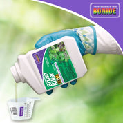 Concentrated brush killer being poured into a measuring cup, ready for garden use.
