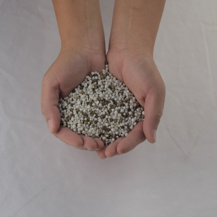 Pre-plant fertilizer pellets for healthy plant growth.
