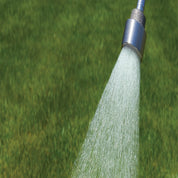 Water breaker nozzle spraying water onto a lush green lawn.
