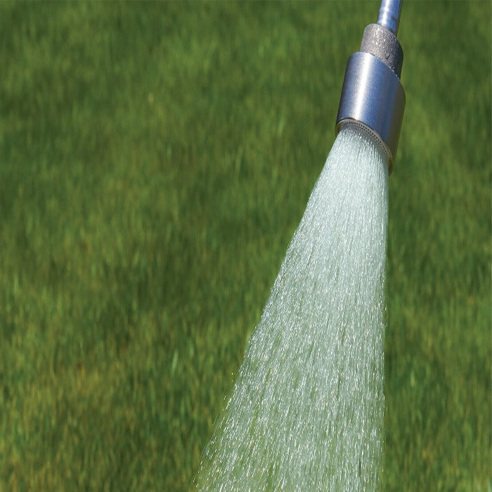 Water breaker nozzle spraying water onto a lush green lawn.
