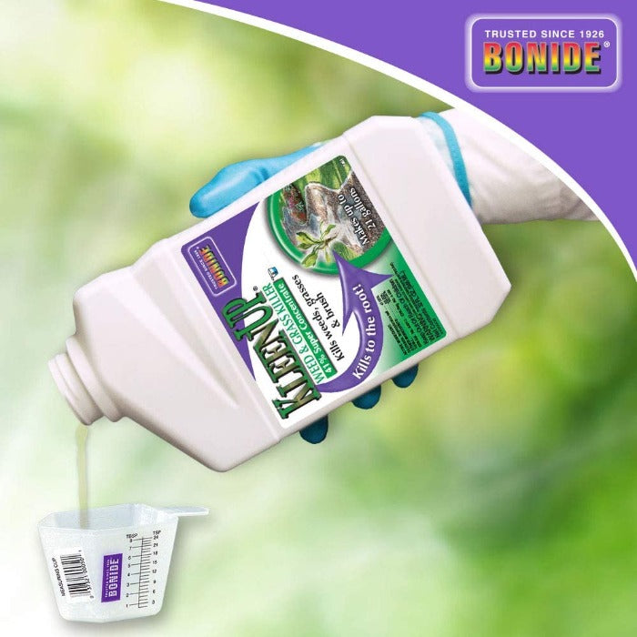 Ready-to-use weed and grass killer being poured into a measuring cup; outdoor setting.
