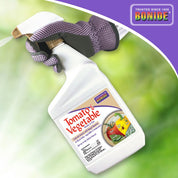 Ready-to-use garden spray bottle for pest and disease control on tomatoes and vegetables; shown in a gloved hand against a blurred green background.
