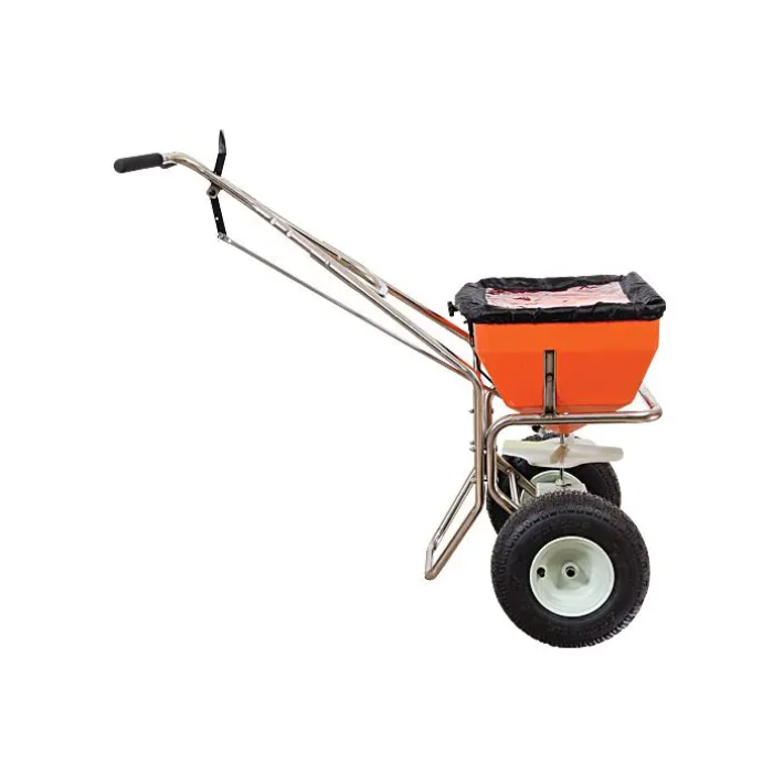 Orange 70lb capacity spreader with stainless steel frame and two large wheels, shown against a white background.
