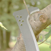 Silver billhook pruning a tree branch outdoors.
