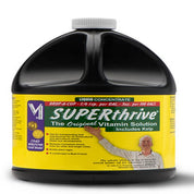 Liquid plant nutrient concentrate in a large black plastic jug with a yellow label, showing usage instructions and kelp inclusion.
