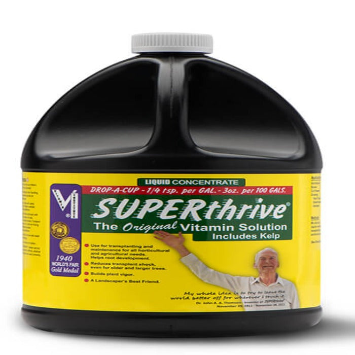 Liquid plant nutrient concentrate in a large black plastic jug with a yellow label, showing usage instructions and kelp inclusion.
