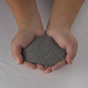 Hands cupping gray MicroClover seed for lush lawns.
