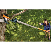Extendable pole saw pruning high branches in a garden.
