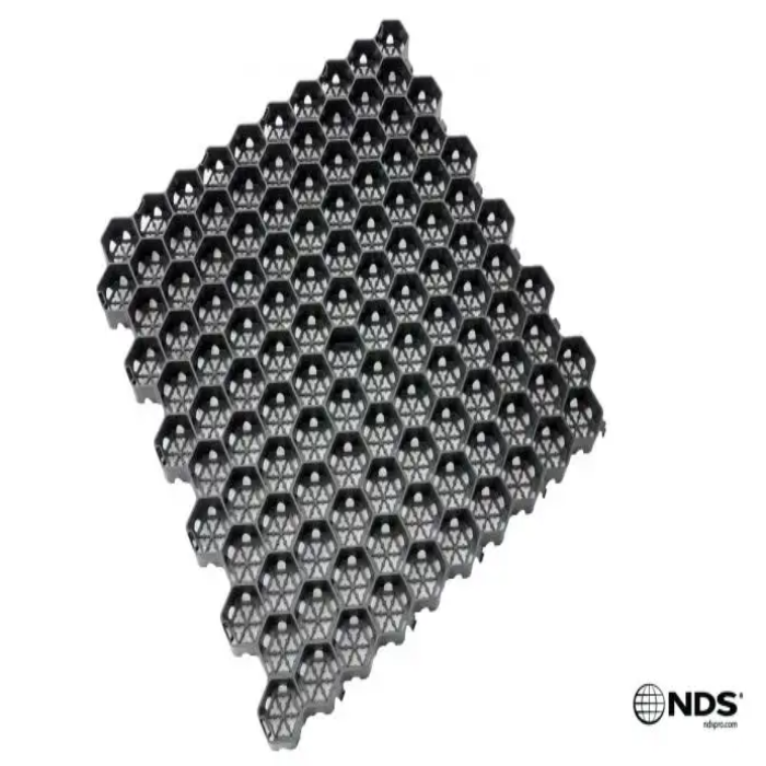 Hexagonal plastic grass pavers for permeable landscaping, shown on white background.
