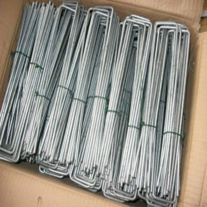 Box of galvanized metal landscape pins, bundled and ready for use.
