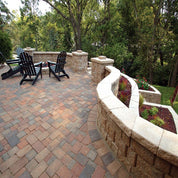 Outdoor patio design with curved retaining wall and integrated planters.
