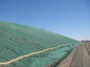 Hydromulch erosion control on a sloped terrain, stabilized with coir logs.

