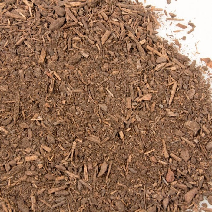 Dark brown compost blend of bark and steer manure, ideal for gardening.
